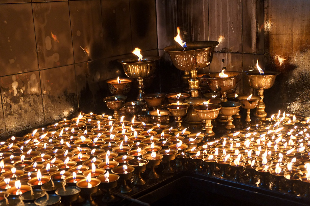 burning butter lamps in BaudhaNath Stupa