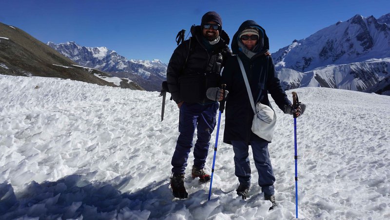 Group of mountaineers walking over a frozen glacier in the Annapurna region, Nepal