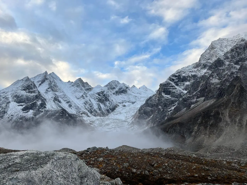 Stunning view of Mount Manaslu surrounded by snow-capped peaks and morning mist during the Manaslu Circuit Trek in Nepal.